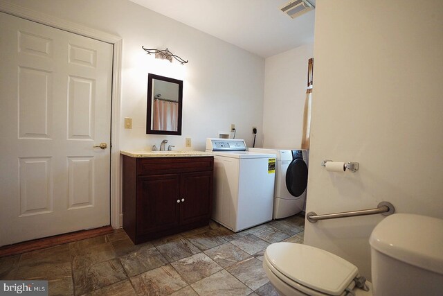 663 Tomlin Station Rd, Mullica Hill, NJ 08062 - full bathroom with washing machine and dryer, toilet, vanity, and stone finish flooring