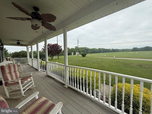 663 Tomlin Station Rd, Mullica Hill, NJ 08062 - wooden porch featuring ceiling fan, a lawn, and a view of countryside