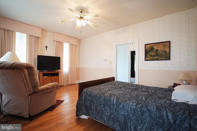 663 Tomlin Station Rd, Mullica Hill, NJ 08062 - bedroom featuring wood finished floors, wallpapered walls, and a ceiling fan