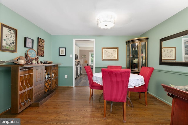 dining room with wood finished floors and baseboards