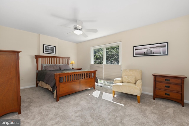 carpeted bedroom with a ceiling fan and baseboards