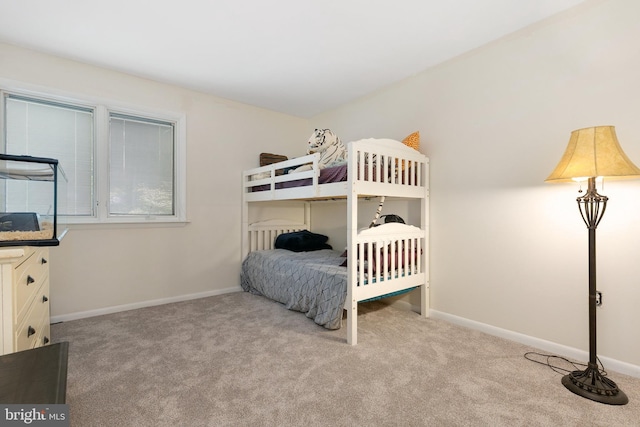 carpeted bedroom featuring baseboards