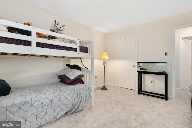 bedroom with carpet flooring and baseboards