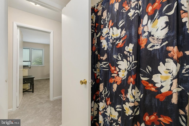 full bathroom with baseboards and a shower with shower curtain