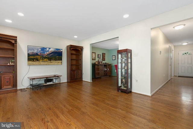 living area with wood finished floors, recessed lighting, and baseboards