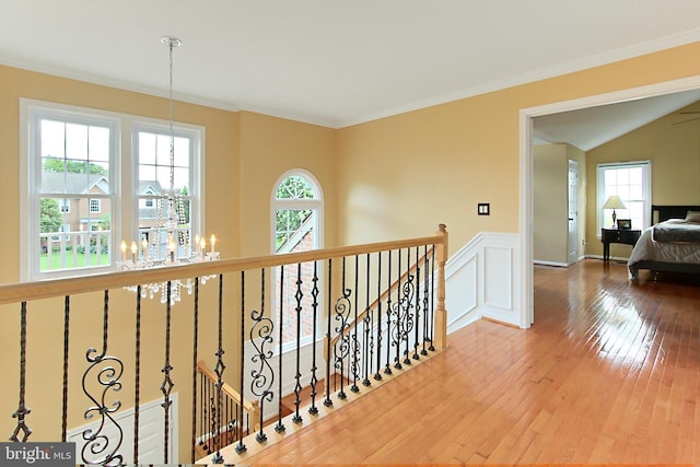 15420 Cedarhurst Ct, Centreville, VA 20120 - hallway featuring a chandelier, healthy amount of natural light, hardwood / wood-style floors, an upstairs landing, and a wainscoted wall