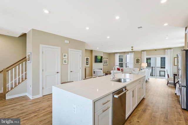 4149 Red Mulberry Dr, Fairfax, VA 22033 - kitchen with a sink, white cabinets, light wood-type flooring, stainless steel appliances, and open floor plan