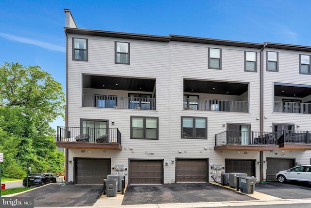 4149 Red Mulberry Dr, Fairfax, VA 22033 - rear view of property featuring a garage, central AC unit, and driveway