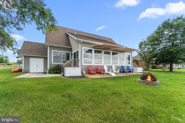 1417 Royal Way, Montross, VA 22520 - rear view of house featuring a fire pit, a sunroom, a patio, a lawn, and roof with shingles