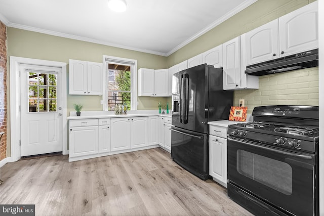 326 E 28th St, Baltimore, MD 21218 - kitchen featuring under cabinet range hood, black appliances, light countertops, white cabinets, and ornamental molding