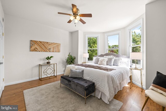 326 E 28th St, Baltimore, MD 21218 - bedroom with hardwood / wood-style flooring, baseboards, and a ceiling fan