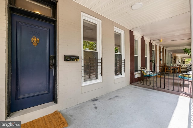 326 E 28th St, Baltimore, MD 21218 - entrance to property with brick siding and a porch