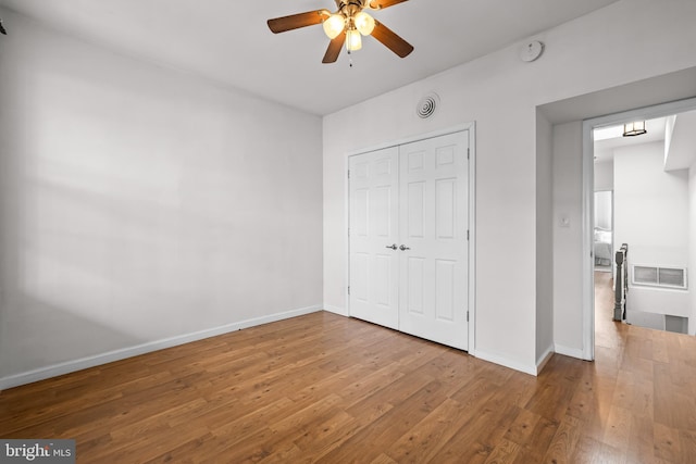 326 E 28th St, Baltimore, MD 21218 - unfurnished bedroom with wood finished floors, baseboards, a closet, and ceiling fan