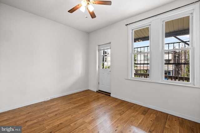 326 E 28th St, Baltimore, MD 21218 - unfurnished room featuring baseboards, wood finished floors, and a ceiling fan