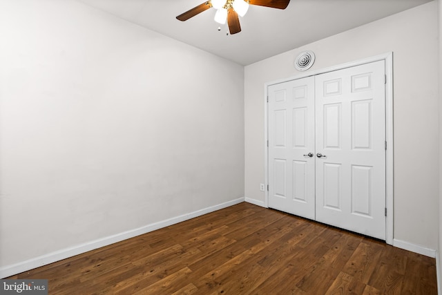 326 E 28th St, Baltimore, MD 21218 - unfurnished bedroom with dark wood-type flooring, baseboards, a closet, and ceiling fan