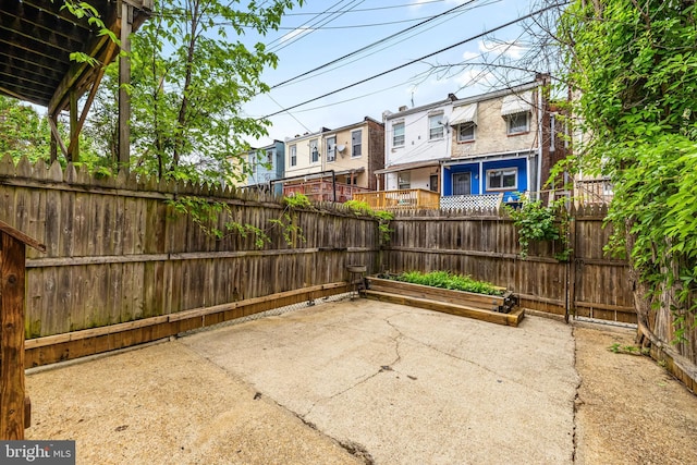326 E 28th St, Baltimore, MD 21218 - view of patio featuring a fenced backyard and a residential view
