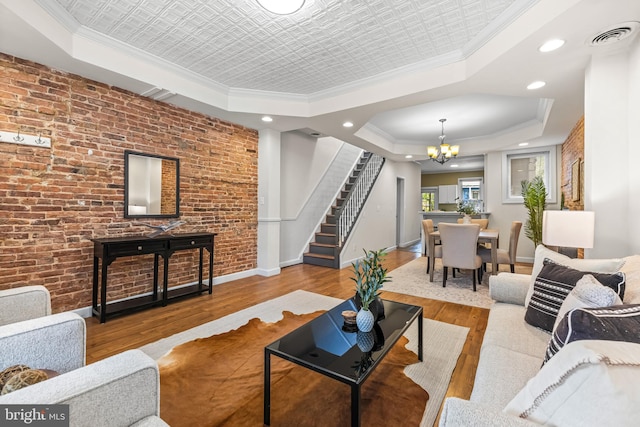 326 E 28th St, Baltimore, MD 21218 - living area featuring a tray ceiling, a chandelier, wood finished floors, stairs, and ornamental molding