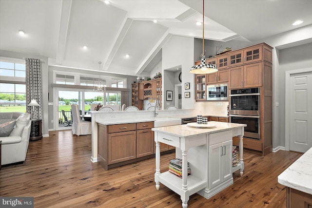 29325 Andrew Jackson Dr, Millsboro, DE 19966 - kitchen featuring a peninsula, stainless steel appliances, brown cabinets, high vaulted ceiling, and plenty of natural light