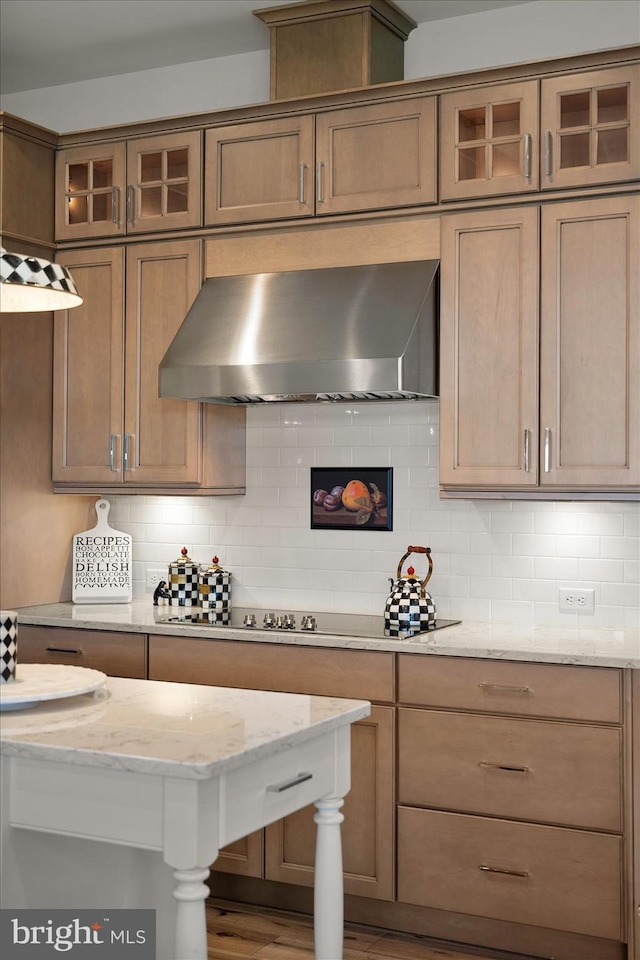 29325 Andrew Jackson Dr, Millsboro, DE 19966 - kitchen featuring wall chimney exhaust hood, backsplash, glass insert cabinets, light stone counters, and black electric stovetop