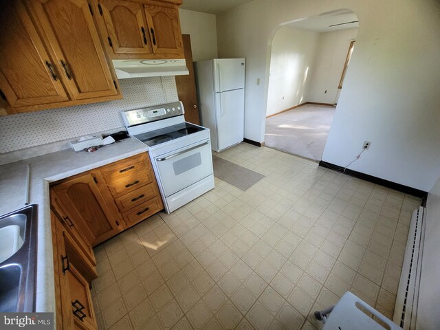 155 Hyndman Rd, Hyndman, PA 15545 - kitchen with white appliances, ventilation hood, arched walkways, light countertops, and baseboards