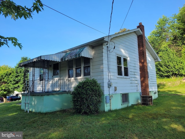 155 Hyndman Rd, Hyndman, PA 15545 - view of side of property featuring a lawn, a chimney, covered porch, and cooling unit