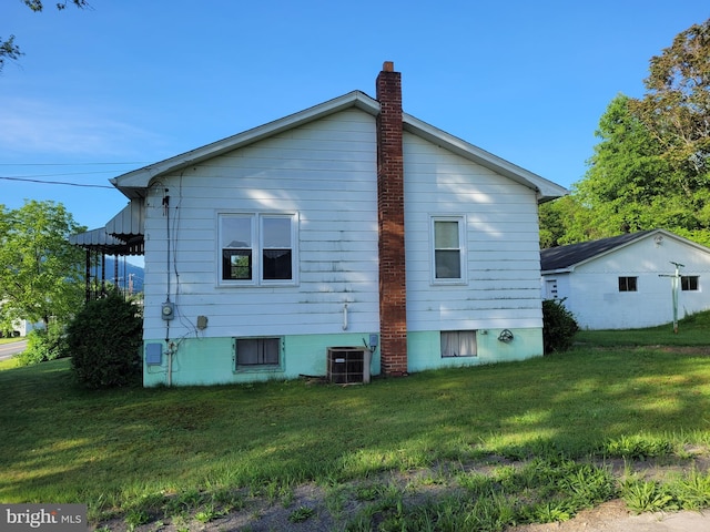 155 Hyndman Rd, Hyndman, PA 15545 - rear view of house featuring a yard, a chimney, and central air condition unit