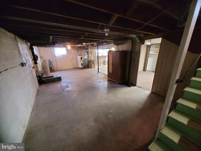 155 Hyndman Rd, Hyndman, PA 15545 - below grade area with electric water heater, stairs, and gas water heater