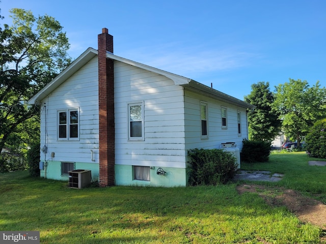 155 Hyndman Rd, Hyndman, PA 15545 - view of side of home featuring a lawn, a chimney, and cooling unit
