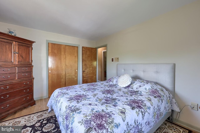 bedroom with a closet and light wood-style flooring