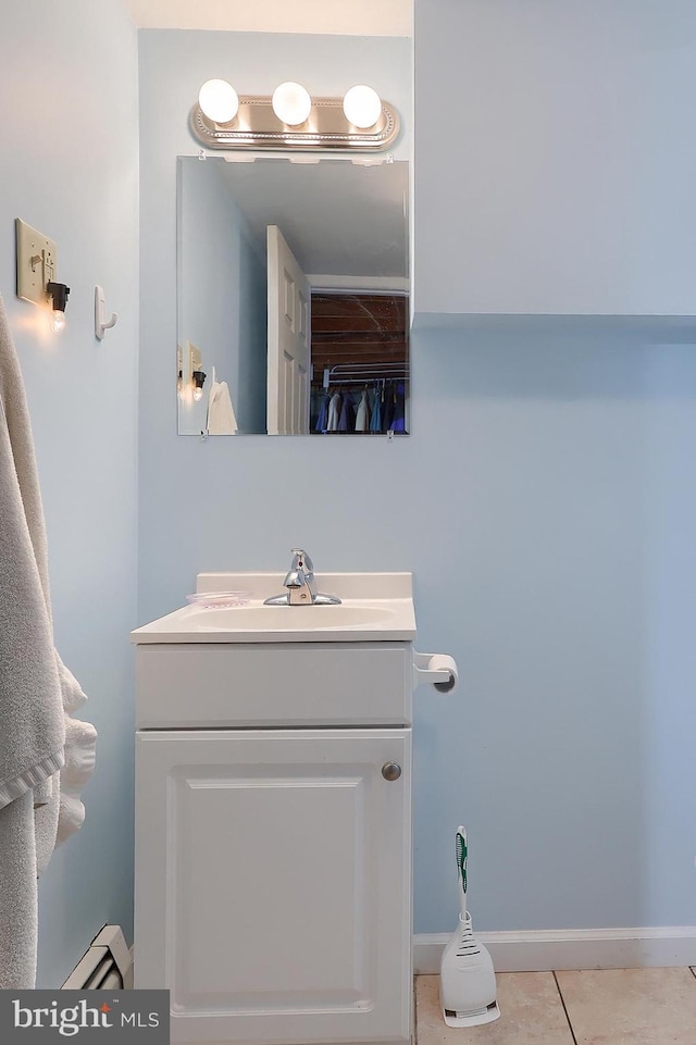 bathroom featuring vanity, a baseboard radiator, tile patterned floors, and baseboards