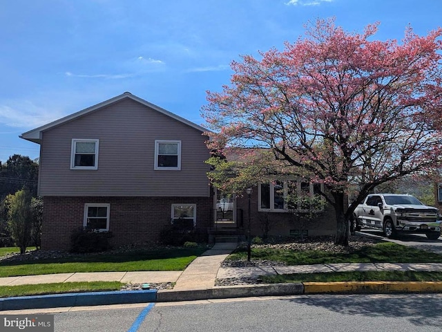 tri-level home with brick siding