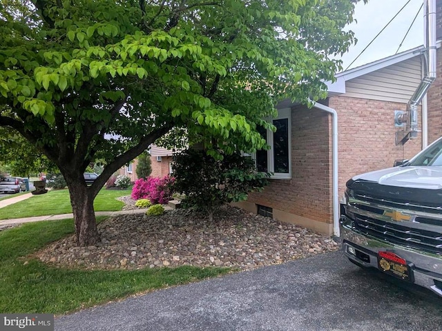 view of side of home featuring brick siding