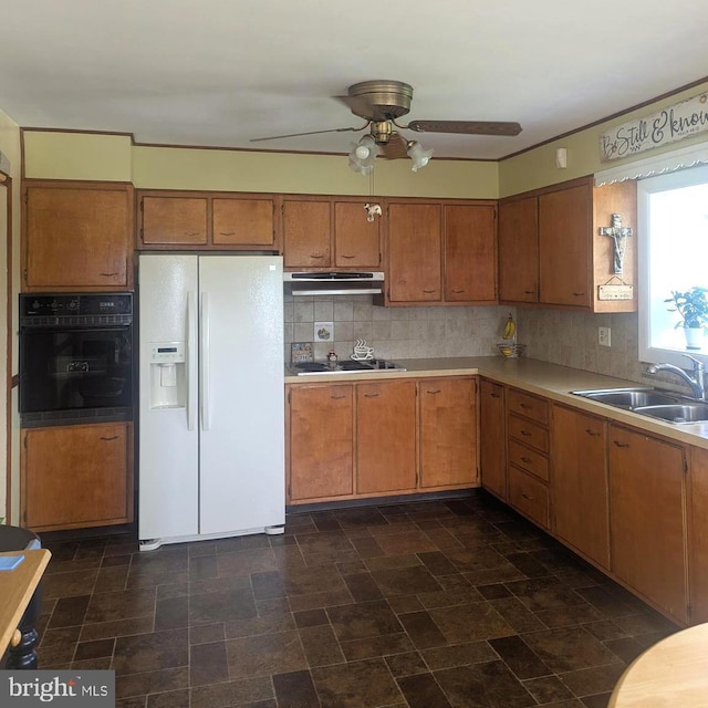 kitchen with black appliances, a sink, a ceiling fan, light countertops, and decorative backsplash
