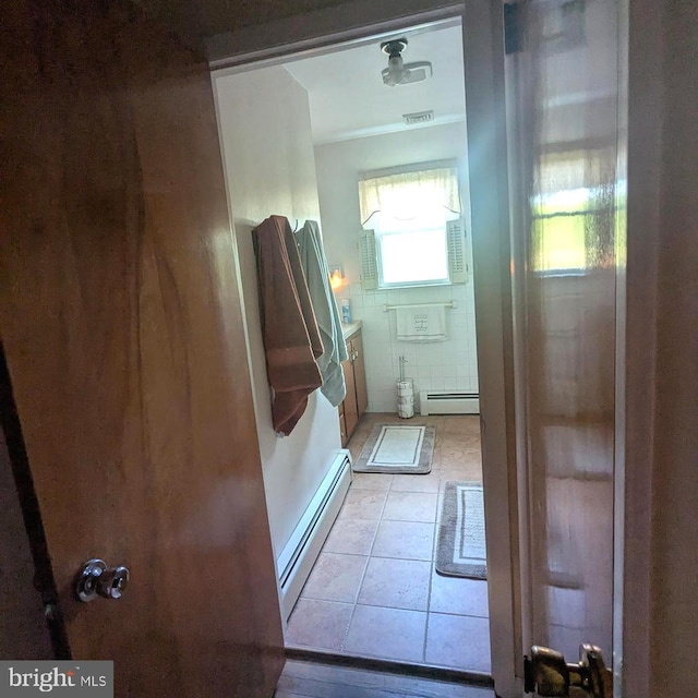 bathroom featuring a baseboard heating unit and tile patterned flooring