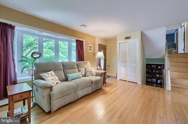 living area with light wood-style floors and baseboards