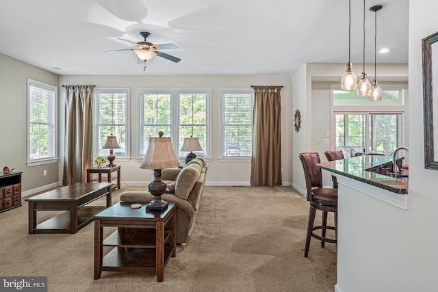 31027 Scissorbill Rd, Ocean View, DE 19970 - living room featuring a ceiling fan, light carpet, and baseboards