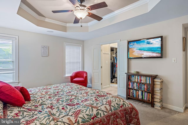 31027 Scissorbill Rd, Ocean View, DE 19970 - bedroom with a tray ceiling, carpet, crown molding, a spacious closet, and baseboards