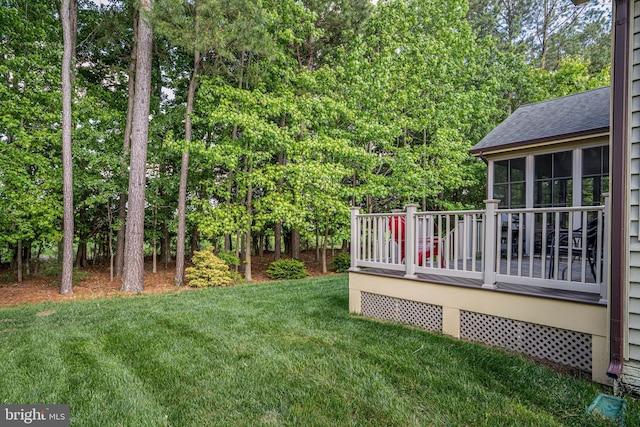 31027 Scissorbill Rd, Ocean View, DE 19970 - view of green lawn featuring a wooden deck and view of wooded area