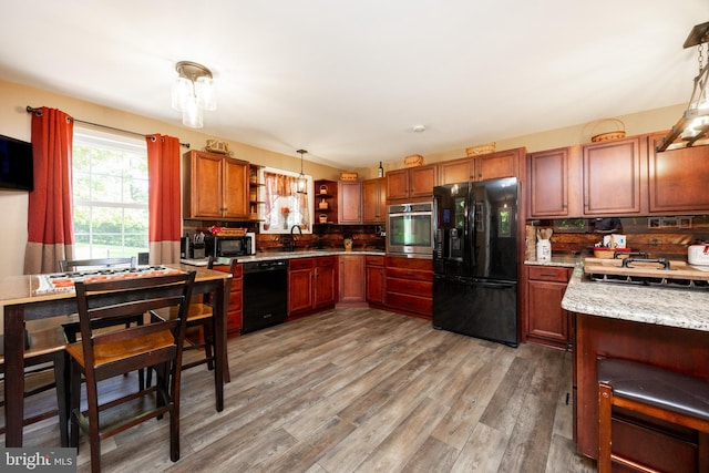 305 Gunhart Rd, Mohnton, PA 19540 - kitchen with black appliances, open shelves, hanging light fixtures, light wood-type flooring, and a sink