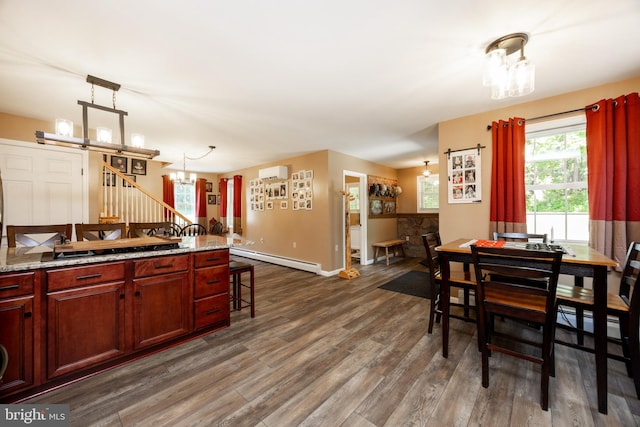 305 Gunhart Rd, Mohnton, PA 19540 - dining area featuring a chandelier, a baseboard radiator, a wall mounted AC, dark wood-type flooring, and baseboards