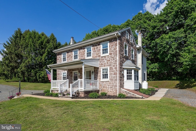 305 Gunhart Rd, Mohnton, PA 19540 - view of front of house with stone siding, a chimney, covered porch, and a front yard
