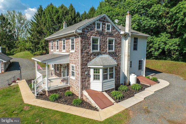305 Gunhart Rd, Mohnton, PA 19540 - view of front facade featuring a porch, a chimney, stone siding, and a front yard