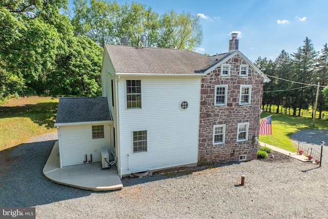 305 Gunhart Rd, Mohnton, PA 19540 - rear view of house with a chimney, stone siding, a patio area, and a shingled roof