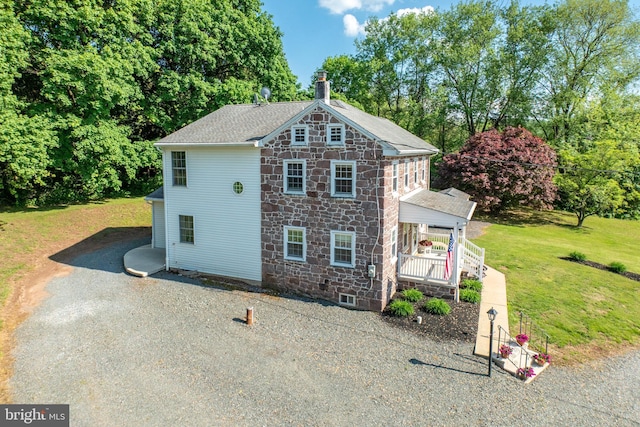 305 Gunhart Rd, Mohnton, PA 19540 - view of side of home with covered porch, stone siding, a chimney, and view of scattered trees