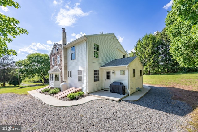 305 Gunhart Rd, Mohnton, PA 19540 - rear view of property featuring a chimney, a lawn, and a patio area