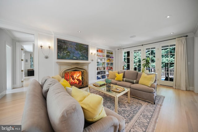 5033 Tilden St NW, Washington, DC 20016 - living room featuring ornamental molding, light wood finished floors, a warm lit fireplace, built in features, and recessed lighting