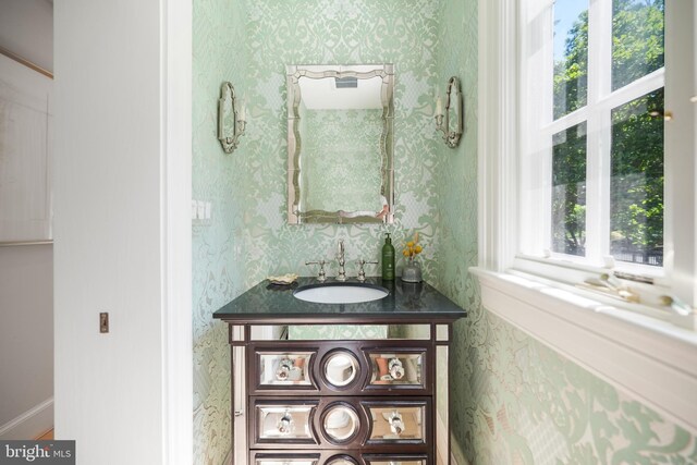 5033 Tilden St NW, Washington, DC 20016 - bathroom with wallpapered walls, vanity, and baseboards