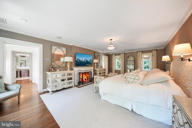 5033 Tilden St NW, Washington, DC 20016 - bedroom with crown molding, wood finished floors, a lit fireplace, and baseboards