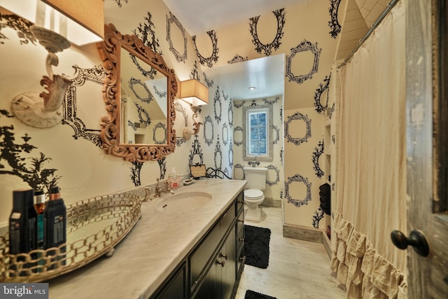 5033 Tilden St NW, Washington, DC 20016 - full bathroom with wood finished floors, toilet, and vanity