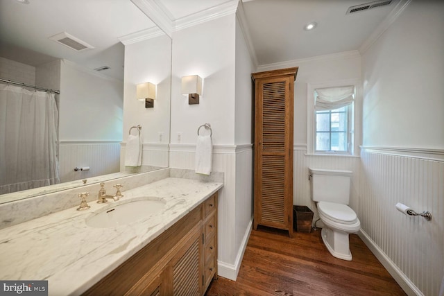 5033 Tilden St NW, Washington, DC 20016 - bathroom featuring a wainscoted wall, toilet, wood finished floors, crown molding, and vanity